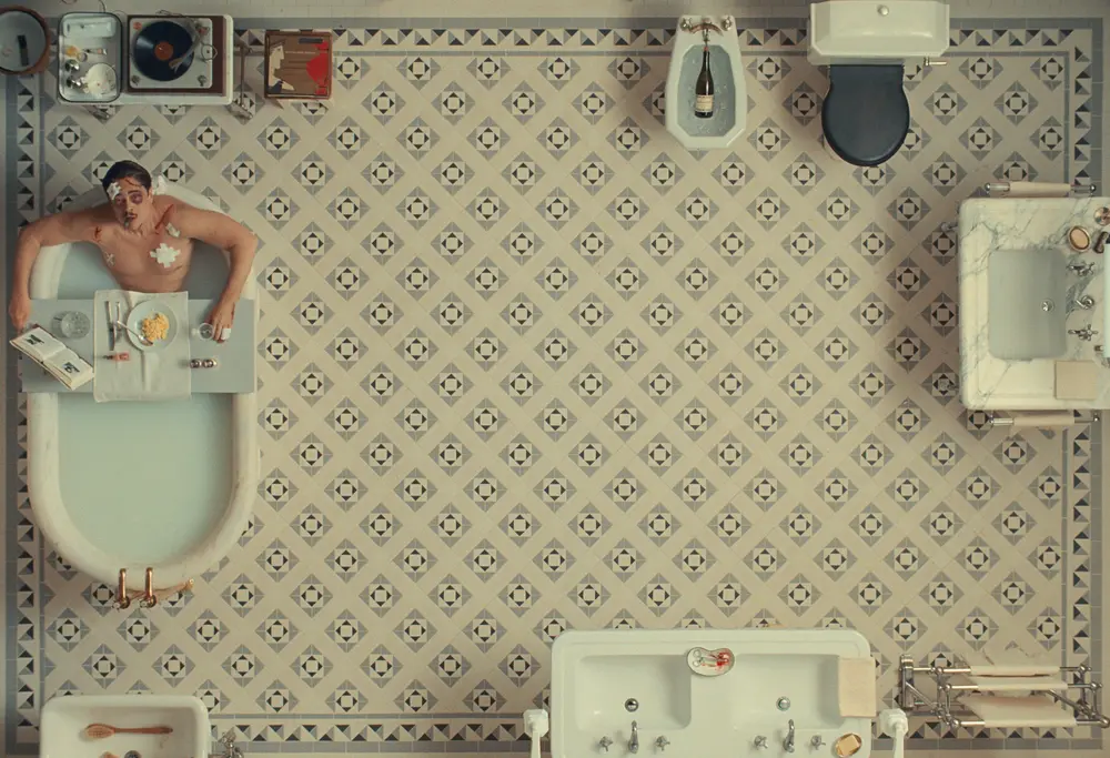 Gorgeous frame from The Phoenician Scheme showing main character in the bathroom